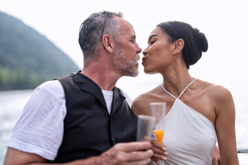 Romantic couple in love have fun sailing in the sea standing on yacht deck enjoy amazing view