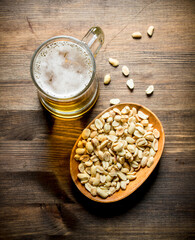 Beer and peanuts in the bowl.