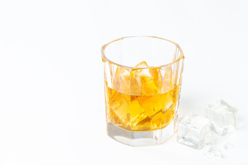Glass of whiskey or brandy with ice. Strong alcohol background