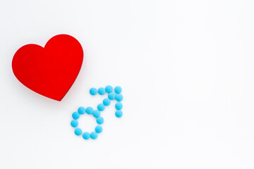 Male sign made of blue pills with red heart. Male medical checkup concept