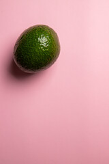 The top view of eco exotic avocado on the pink background 