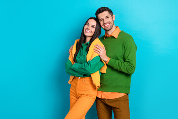 Photo of cute sweet couple charming lady nice man wear stylish clothes hugging presenting empty space isolated on blue color background