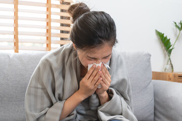 Sick day at home. Asian woman has runny and common cold.