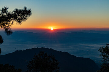View of  Beautiful landscape in the mountains at sunrise in the morning. Beautiful sky background and the foggy hills covered. Nature tourism, healthy lifestyle concept and beautiful nature.