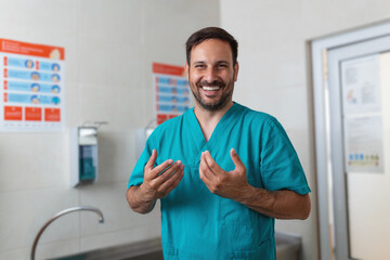 Doctor washing hands with soap. Male surgeon is preparing for surgery. He is in uniform