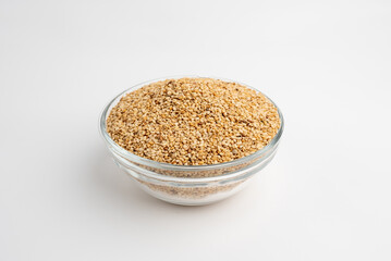 Sesame seeds  in a glass dish on a white background
