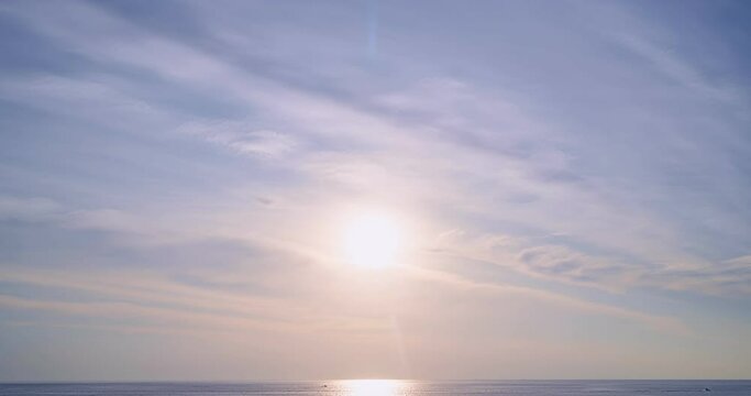 Time lapse of Majestic sunset light over sea landscape,Amazing light of nature cloudscape sky and Clouds moving away rolling, Colorful sunset or sunrise light dramatic clouds in golden hour Footage