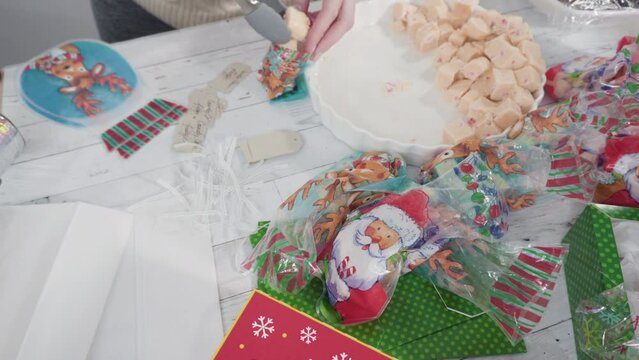 Step by step. Packaging homemade candy cane fudge into small gift bags.