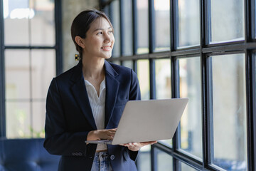 Beautiful asian woman in suit working on virtual computer in office small business owner person freelancer online marketing sme telemarketing concept