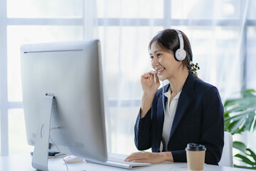 Female customer support telephone operator, beautiful smiling asian woman in office space...