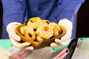 Homemade oatmeal cookies with candied fruit in a heart-shaped plate