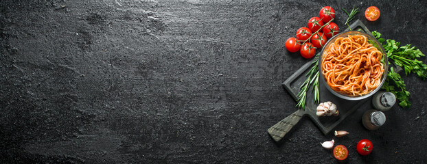 Pasta in a bowl with tomatoes,herbs and garlic.