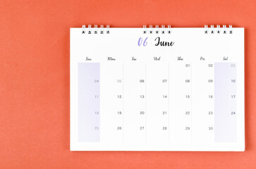 The June 2023 calendar desk for the organizer to plan and reminder on red background.