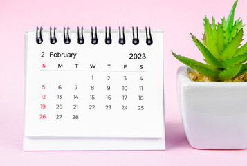 The February 2023 desk calendar for 2023 on pink colour background.