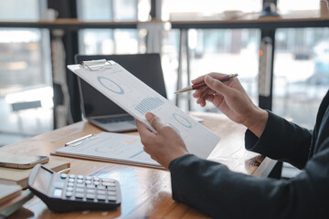 Businessman and Certified Public Accountant (CPA) auditor providing accounting and auditing services in the same company and stock market chart data and anti bribery of accounting