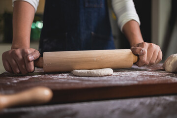 Chef use Rolling pin on dough