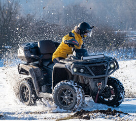 Man driving quad in the snow © Ilija