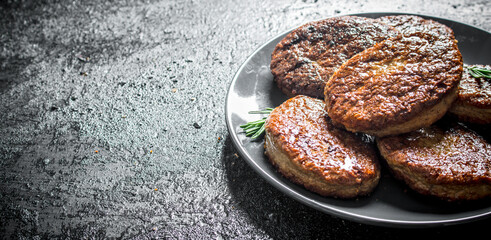 Cutlets on a plate with rosemary.