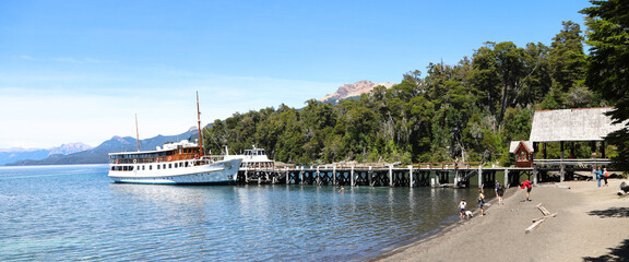 Anchorena Port. Victoria Island. Historic ship named Modesta Victoria. Lake Nahuel Huapi, Rio Negro, Argentina. Argentine Patagonia. Tourists on the beach. Landscape.