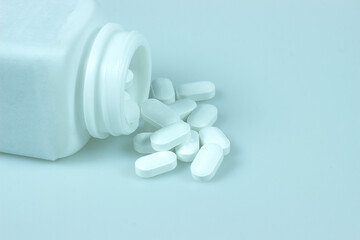 pills and bottle on white background