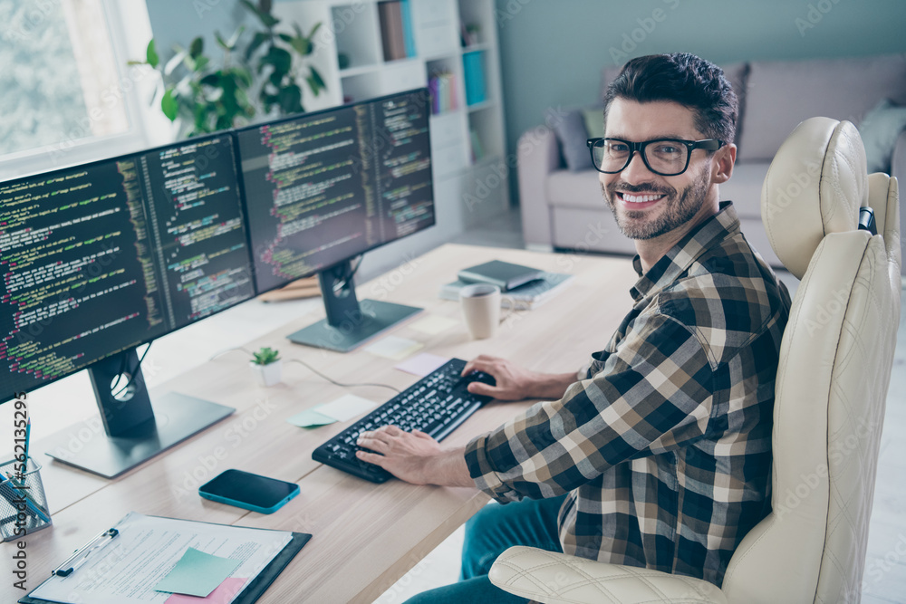 Poster photo of happy cheerful coder dressed eyewear writing keyboard web designing indoors workplace works