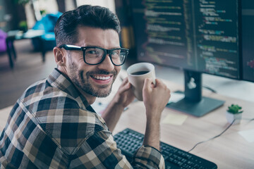 Profile photo of smart positive hacker guy arms hold fresh morning coffee toothy smile operating...