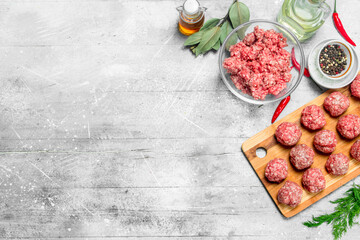 Raw beef meatballs with spices and fragrant dill .