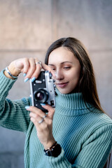 Beautiful young hipster girl with old camera. 