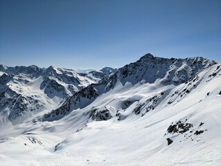 Fototapeta na wymiar Mountain panorama on the Pischahorn above Davos Mountains. Beautiful mountain landscape with snowy mountain peaks