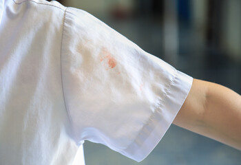 dirty stain on kid shirt at part of shirt from daily life activity for cleaning concept. selective focus.