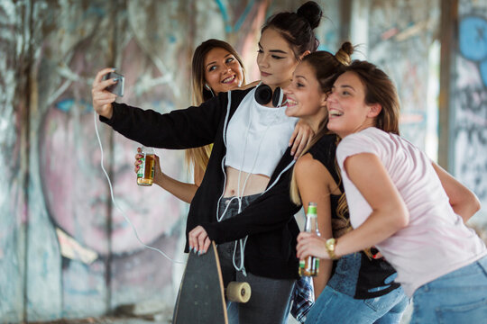 Group of girls taking a selfie while drinking