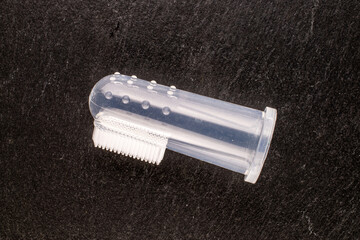 Naklejka premium One dog toothbrush, macro, on slate stone, top view.