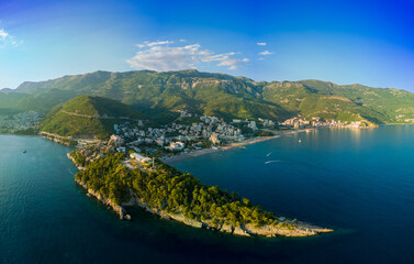 Obraz premium Panorama of bird's eye view of towns of Budva and Becici with hotels and beaches near Adriatic Sea against the backdrop of the Montenegrin Mountains