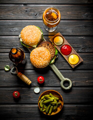Burgers with beer,gherkins and sauces.