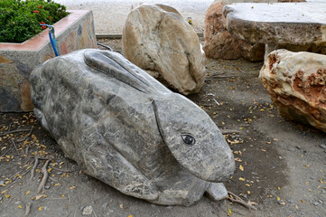 Closeup of Beautiful Stone carving in the shape of a crouching rabbit placed inside the garden for beautiful decoration at Thailand.
