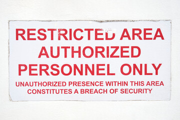 Restricted area authorized personnel only sign on white background. White weathered restricted area...