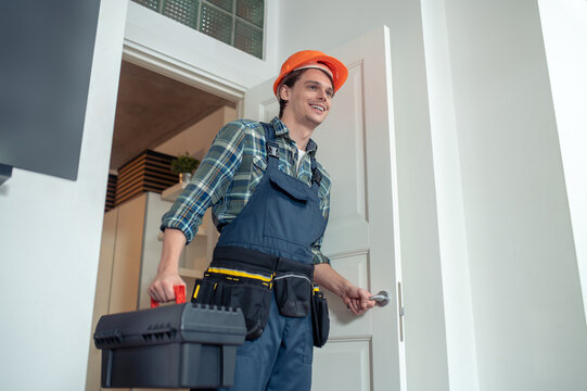 Smiling friendly serviceman arriving at the customer house