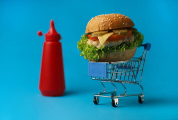 
juicy delicious fresh burger buns with sesame seeds, green salad, tomatoes, cucumbers, fragrant...