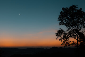 Fototapeta na wymiar View of moon and star in blue hour before sunrise