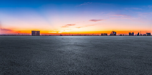 Asphalt road and city skyline with modern buildings in Shanghai at sunrise, China. Panoramic view.