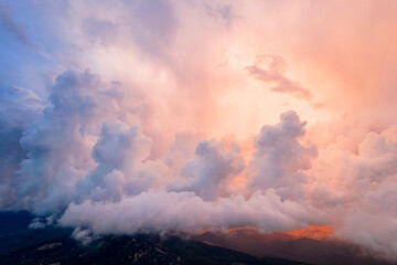 Fototapeta na wymiar Panoramic view of the mountains in incredible clouds shot in the beautiful sunset light. Drone shot top view.