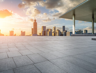 Empty square floor and modern city skyline with buildings at sunset in Ningbo, Zhejiang Province, China. 