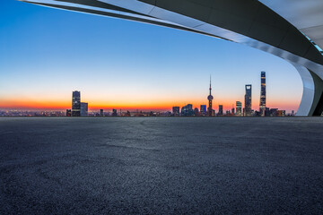 Fototapeta na wymiar Asphalt road and city skyline with modern buildings in Shanghai at sunrise, China.