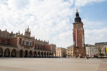 Town Hall Tower (Wieża Ratuszowa) and Cloth Hall (Sukiennice Kraków) on Main Market Square in the Old Town Krakow, Poland. Decorated with Polish flag for celebration of 3 May Constitution Day.