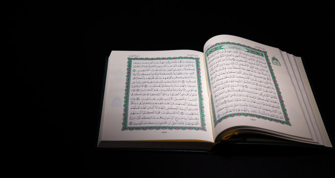 Quran - holy book of Muslims religion, Concept: open book holy prayers for god, Friday In the month of Ramadan religion Islamic worshiping faith and learn koran and rosary put on black floor