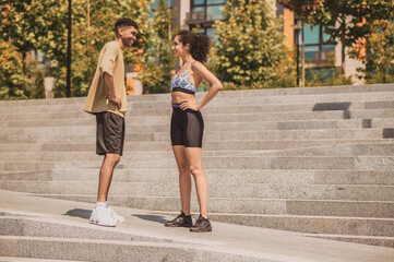 Cheerful athletic couple engaged in conversation