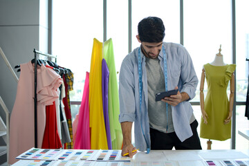 Young designer with his dress, Fashion design.