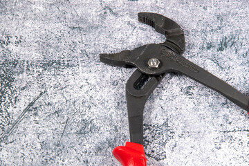 Pipe wrench open made of cast iron with red handle