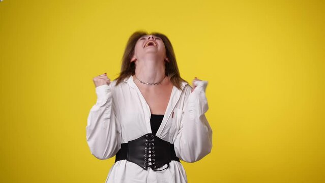 4k video of one girl is so excited over yellow background.