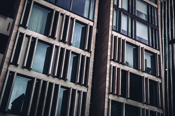 Detail of a generic modern building. Filtered background image of glass, steel and reflections
